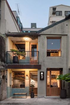 an apartment building with two balconies on the second floor