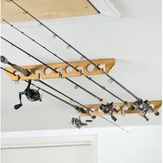 there are many fishing rods hanging from the ceiling