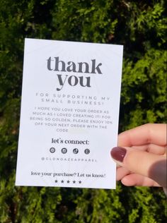 someone holding up a thank you card in their hand