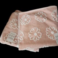 the pink and white flowered blanket has tags on it