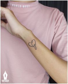 a woman's arm with a small tattoo design on the left side of her wrist