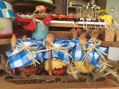 apples wrapped in blue and white checkered cloth with wooden spoons tied around them