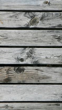 an old wooden planks with knots and holes in it