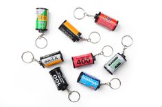 several batteries are arranged in the shape of a key chain on a white surface,