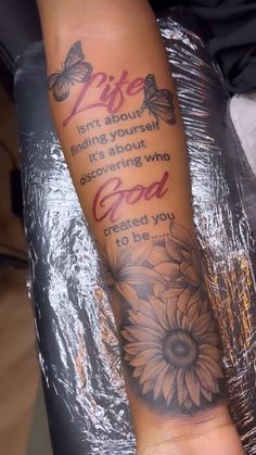 a woman's arm with a sunflower and bible verse tattooed on the side