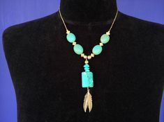 Make a statement on a tight budget...  listing is now for just one of the two... The other one in the pictures sold, so now the listing is just for the one in the solo pictures.Native American strung turquoise color beads (magnesite or Howlite) necklace with silver tone metal spacer beads & feathers... obtained at Kewa / Santo Domingo Pueblo.  each necklace hangs 12.5" long Adjustable Turquoise Jewelry With Feathers, Bohemian Turquoise Jewelry With Feathers, Turquoise Bohemian Jewelry With Feathers, Turquoise Feather Jewelry As Gift, Turquoise Feather Jewelry As A Gift, Bohemian Howlite Beaded Necklace For Gifts, Bohemian Howlite Jewelry Gift, Bohemian Howlite Jewelry For Gifts, Bohemian Howlite Jewelry As Gift