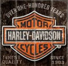 an orange and black harley davidson sign on a wooden background with the words motor harley - davidson style