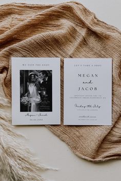 two wedding cards on top of a blanket