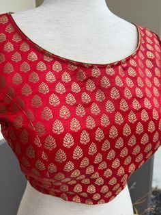 Pure Banarasi Red Color Blouse with small Gold Buttis in Zari Weaving. Comes with Cups attached to the blouse. Please note : Blouses has margin to open 2 sizes up. Item : Ready to Wear BlouseColor : Red Blouse Fabric : Pure Banarasi SilkBlouse Fitting : Princess Cut Lining : Yes, it is fully lined Padded or Non-Padded : Padded Closure: Back Closure with hooks.Ready-to-Wear : YesDisclaimer - :-This is a Standard Size blouse. We do not guarantee perfect fit as every body and shape is different. Li Festive Zari Work Tops For Celebration, Red Semi-stitched Blouse For Wedding, Fitted Red Blouse For Celebration, Traditional Red Party Tops, Anarkali Blouse With Zari Weaving, Festive Red Unstitched Blouse Piece, Red Banarasi Silk Blouse Piece For Navratri, Festive Red Semi-stitched Blouse, Red Festive Blouse For Wedding