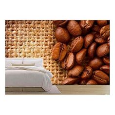 a bed sitting next to a wall covered in lots of coffee beans on top of it