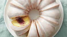 a white plate topped with a bundt cake covered in frosting