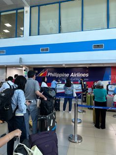 people are waiting in line at the airport for their bags to be picked up and taken off