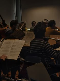 a group of people playing musical instruments in an auditorium