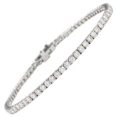 Exquisite and timeless diamonds tennis bracelet, by Alexander Beverly Hills. 65 round brilliant diamonds, 3.96 carats total. Approximately G color and VS clarity. Four prong set in 18k white gold, 8.20 grams, 7 inches. Accommodated with an up-to-date digital appraisal by a GIA G.G. once purchased, upon request. Please contact us with any questions. Item Number MD039NP Bracelet Tennis, Tennis Bracelet Diamond, Brilliant Diamond, Tennis Bracelet, Round Brilliant, Diamond White, Beverly Hills, Prong Setting, Alexander