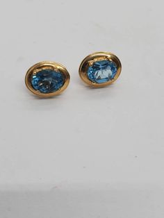 Vintage Oval Blue Topaz And 14 Karat Yellow Gold Stud Earrings These earrings are incredible they are marked 14 karat on the backside the oval cut topaz stones are very beautiful and very sparkly the stones measure approximately 7 mm by 9 mm the overall weight is 3.1 grams Oval Topaz Earrings For Formal Occasions, Oval Topaz Earrings For Anniversary, Formal Oval Topaz Earrings, Oval Topaz Earrings As Gift, Oval Topaz Earrings For Gift, Oval Gold Topaz Earrings, Oval Blue 14k Gold Earrings, Blue Oval 14k Gold Earrings, Gold Oval Blue Topaz Earrings