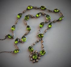 "Entrancing and very rare Georgian necklace, circa 1800 Peridot green foiled paste jewels accented with diamond paste spacers. The green paste stones glow in the light. Rivieres with drops like this are incredibly difficult to find! Measurements\" Necklace - 19\" with an additional 1 3/4\" for the drop Each green paste - 1/2\" with loops Light wear, fitting for age. No damage or repairs to note. Please note, insurance is not included in the postage cost. Please contact me for a quote if interest Formal Green Stone Necklace, Formal Green Stone Necklaces, Green Victorian Necklace For Wedding, Fine Jewelry Green Necklace With Stones, Antique Green Jeweled Necklace, Antique Green Jeweled Necklaces, Vintage Green Jewelry With Rose Cut Diamonds, Green Peridot Necklace In Fine Jewelry Style, Oval Green Jeweled Jewelry