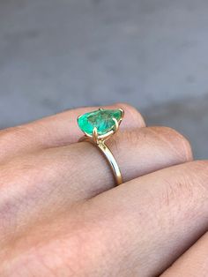 Displayed is a classic Colombian emerald solitaire teardrop/pear-cut engagement ring in 14K yellow gold. This gorgeous solitaire ring carries a full 2.24-carat emerald in a secure five-prong setting. Fully faceted, this gemstone showcases excellent shine. The emerald has excellent clarity with minor flaws that are normal in all genuine emeralds but no carbon spots (black) or harsh flaws are found in this beauty! The gem has a medium, bluish-green color, and excellent luster. An ideal solitaire, Green Emerald Ring With Prong Setting In Pear Shape, Pear-shaped Green Emerald Ring With Prong Setting, Green Pear-shaped Emerald Ring With Prong Setting, Teardrop Emerald Ring With Prong Setting, Pear-shaped Emerald Ring For Promise, Green Pear-shaped 14k Gold Rings, Pear-shaped Solitaire Emerald Ring For Anniversary, Pear-shaped Emerald Ring In 14k Gold, Pear-shaped Emerald Solitaire Ring