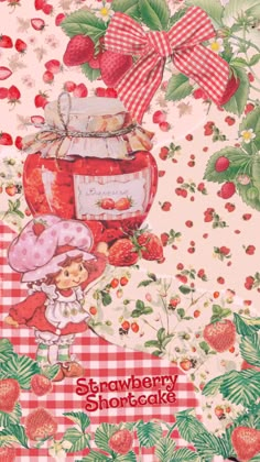 strawberry shortcakes on a checkered tablecloth with strawberries and cherries