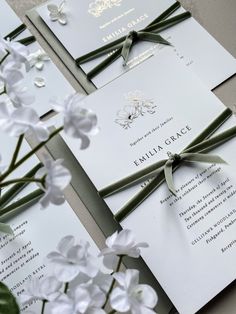 the wedding stationery is laid out on top of each other and tied with ribbon