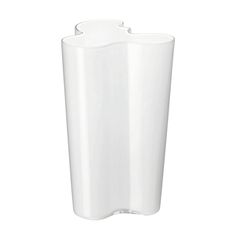 a white vase sitting on top of a table