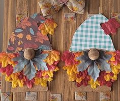 two fall decorations made out of paper leaves on a wooden board with bows and magnets