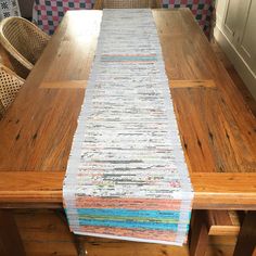 a wooden table topped with lots of different types of papers on top of each other