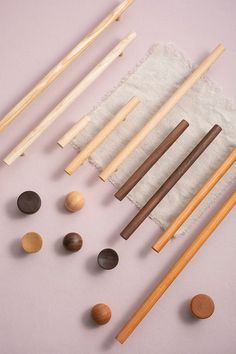 several different types of wooden spoons and chopsticks laid out on a cloth