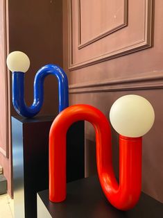 two different colored objects sitting on top of a black table in front of a door