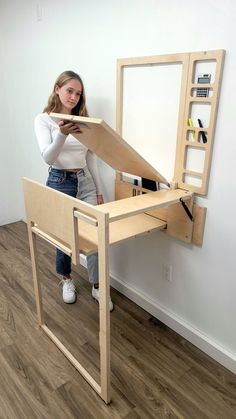 a woman is standing in front of a mirror with her hands on the edge of it