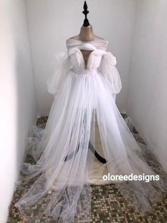 a mannequin is dressed in white tulle and veil