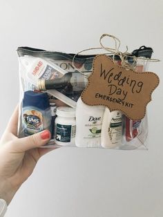 a person holding up a bag filled with personal care items and an ornament that says wedding day emergency kit