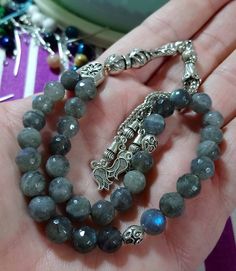 ✔️ 8 mm faceted Beads. ✔️ AAA grade Natural Labradorite Stone ✔️ Natural Color ✔️ This glamorous tasbih is a very special gift for your loved ones. ✔️ Each order comes in a special box. ✔️ PLEASE CLICK THE LINK FOR ALL PRAYER BEADS MODELS https://www.etsy.com/shop/GoodJewelsofYazmasal Note: As a natural feature the stones beads may have some variations. SHIPPING: United States (Standart/DHL eCommerce/usps): 7-10 business days United States (Express/FedEx): 3-5 business days Canada (Express/FedEx Faceted Spiritual Beads For Gifts, Spiritual Silver Faceted Beads, Silver Beads Gems And Cabochons For Gifts, Handmade Rosary With Round Beads As Gift, Silver Rosary With Faceted Round Beads, Silver Rosary With Faceted Beads, Gemstone Beads Rosary As Gift, Adjustable Rosary With Faceted Round Beads, Silver Faceted Beads For Jewelry Making