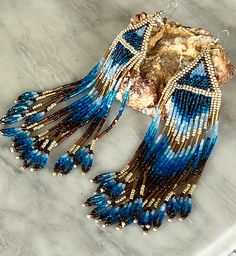 Unique Native made hand beaded earrings glass beads Blue Fringe Dangle Chandelier Earrings, Blue Beaded Fringe Earrings For Festival, Bohemian Blue Beaded Fringe Earrings, Blue Bohemian Beaded Fringe Earrings, Blue Fringed Beaded Earrings For Festival, Unique Fringed Dangle Beaded Earrings, Unique Fringe Dangle Beaded Earrings, Festival Beaded Earrings With Fringe, Unique Fringe Beaded Earrings For Festivals