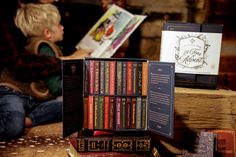 Close-up of the 24 Teas of Advent—Piper and Leaf Advent Calendar 2024 by Piper & Leaf Tea Co. featuring 24 numbered tea boxes. A child reads a book in the blurred background. Bookshelf Collection, Tea Advent Calendar, Gospel Of Luke, Calendar 2024, Tea Bags, A Song, Tea Bag, Corporate Gifts, Diwali