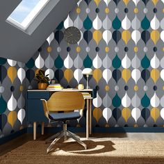 a room with a desk and chair in front of a wallpapered pattern that has circles on it