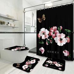 a bathroom with black and pink flowers on the shower curtain, toilet seat cover and rug