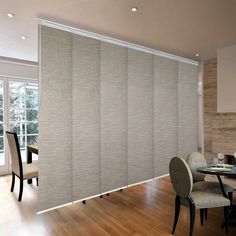 a dining room with wooden floors and sliding glass doors