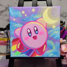 a painting of a cartoon character with stars and moon in the sky, on a easel