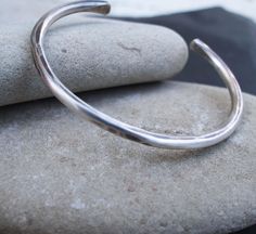 "Our rustic silver cuff is hand forged from heavy gauge sterling silver. The cuff is polished to a high shine and then lightly oxidized to bring out the detail and hammer strikes. Simple, minimalist, a perfect everyday piece. My husband gives me a bangle to celebrate each milestone in our life together. I look forward to one day being an old woman with and arm full of bangles. I created this piece for him as a daily reminder of my love. Sizes : Extra Small - inside circumference of 6\" with a 1\ 19th Anniversary, Silver Anniversary Gifts, Bronze Anniversary Gifts, Bronze Anniversary, Bronze Bracelets, Silver Anniversary, Mens Bracelet Silver, Anniversary Present, Personalized Anniversary