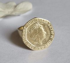 Signet ring women, gold coin ring, signet ring, pinky coin ring, coin ring, vintage ring, cocktail ring, graduation gift, gold pinky ring This coin ring is made of an old British 20p coin which was attached to a wide band to create a lovely signet ring for women. The pinky coin ring is available both in 14k gold plating and sterling silver The gold signet ring was designed in a vintage style and is just a great gift for women. Dimensions: The coin diameter is 2 cm (a bit over 0.75 inches) The co Vintage Coin Signet Ring As Gift, Vintage Coin Signet Ring For Gift, Vintage Coin Shaped Signet Ring Gift, Elegant Engraved Coin Rings, Hallmarked Coin Shaped Signet Ring As Gift, Gold Coin-shaped Signet Ring For Gift, Gold Coin Signet Ring For Gift, Gold Coin Shaped Signet Ring For Gift, Gold Coin Shaped Signet Ring