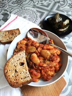 a bowl filled with pasta and bread on top of a table