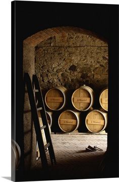 wine barrels are stacked up in an old cellar