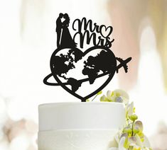 a wedding cake topper with the word mr and mrs on it in front of a heart