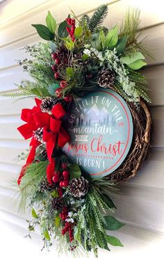 a christmas wreath hanging on the side of a house