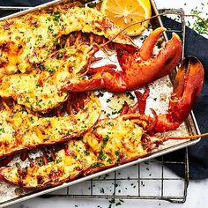 lobsters and cheese on a tray with lemon wedges