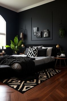 a bedroom with black walls and wooden flooring has a large bed in the middle