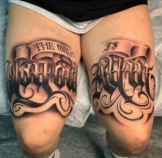 the legs are covered with tattoos and lettering