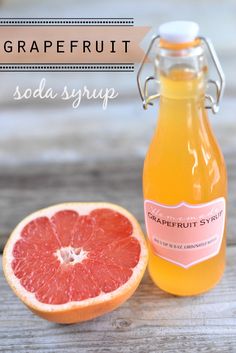 grapefruit soda syrup in a glass bottle next to an open grapefruit