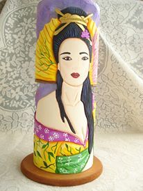 a decorative vase with a woman's face painted on it