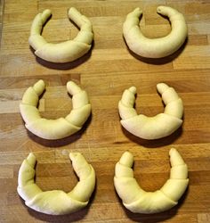 four doughnuts shaped to look like teeth on a wooden surface